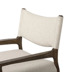 A midcentury-inspired piece, updated for modern times. A supportive back and seat cushion are upholstered in high-performance fabric, with walnut-finished wooden armrests prime for the head of the table. Steam regularly to keep fabric looking crisp. Amethyst Home provides interior design, new home construction design consulting, vintage area rugs, and lighting in the Dallas metro area.
