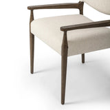A midcentury-inspired piece, updated for modern times. A supportive back and seat cushion are upholstered in high-performance fabric, with walnut-finished wooden armrests prime for the head of the table. Steam regularly to keep fabric looking crisp. Amethyst Home provides interior design, new home construction design consulting, vintage area rugs, and lighting in the Nashville metro area.