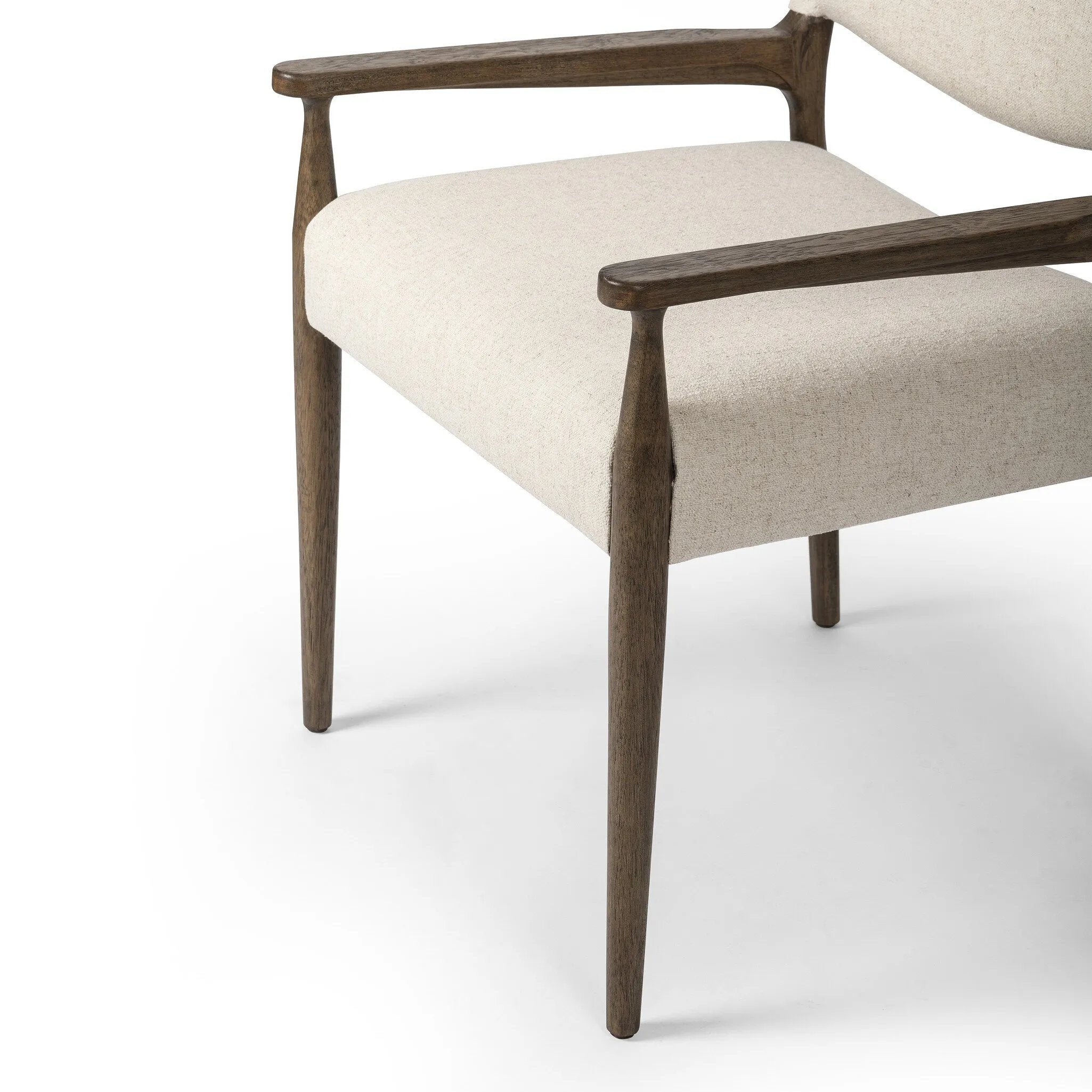 A midcentury-inspired piece, updated for modern times. A supportive back and seat cushion are upholstered in high-performance fabric, with walnut-finished wooden armrests prime for the head of the table. Steam regularly to keep fabric looking crisp. Amethyst Home provides interior design, new home construction design consulting, vintage area rugs, and lighting in the Nashville metro area.