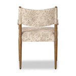A midcentury-inspired piece brought to modern speed. A supportive, sling-style back and seat cushion are upholstered in a soft, velvety fabric, with toasted oak arms prime for the head of the table Amethyst Home provides interior design, new home construction design consulting, vintage area rugs, and lighting in the Tampa metro area.