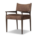A midcentury-inspired piece brought to modern speed. A supportive, sling-style back and seat cushion are upholstered in a soft, velvety fabric, with toasted oak arms prime for the head of the table Amethyst Home provides interior design, new home construction design consulting, vintage area rugs, and lighting in the Houston metro area.
