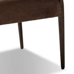 A midcentury-inspired piece brought to modern speed. A supportive, sling-style back and seat cushion are upholstered in a soft, velvety fabric, with toasted oak arms prime for the head of the table Amethyst Home provides interior design, new home construction design consulting, vintage area rugs, and lighting in the Nashville metro area.