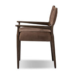 A midcentury-inspired piece brought to modern speed. A supportive, sling-style back and seat cushion are upholstered in a soft, velvety fabric, with toasted oak arms prime for the head of the table Amethyst Home provides interior design, new home construction design consulting, vintage area rugs, and lighting in the Omaha metro area.