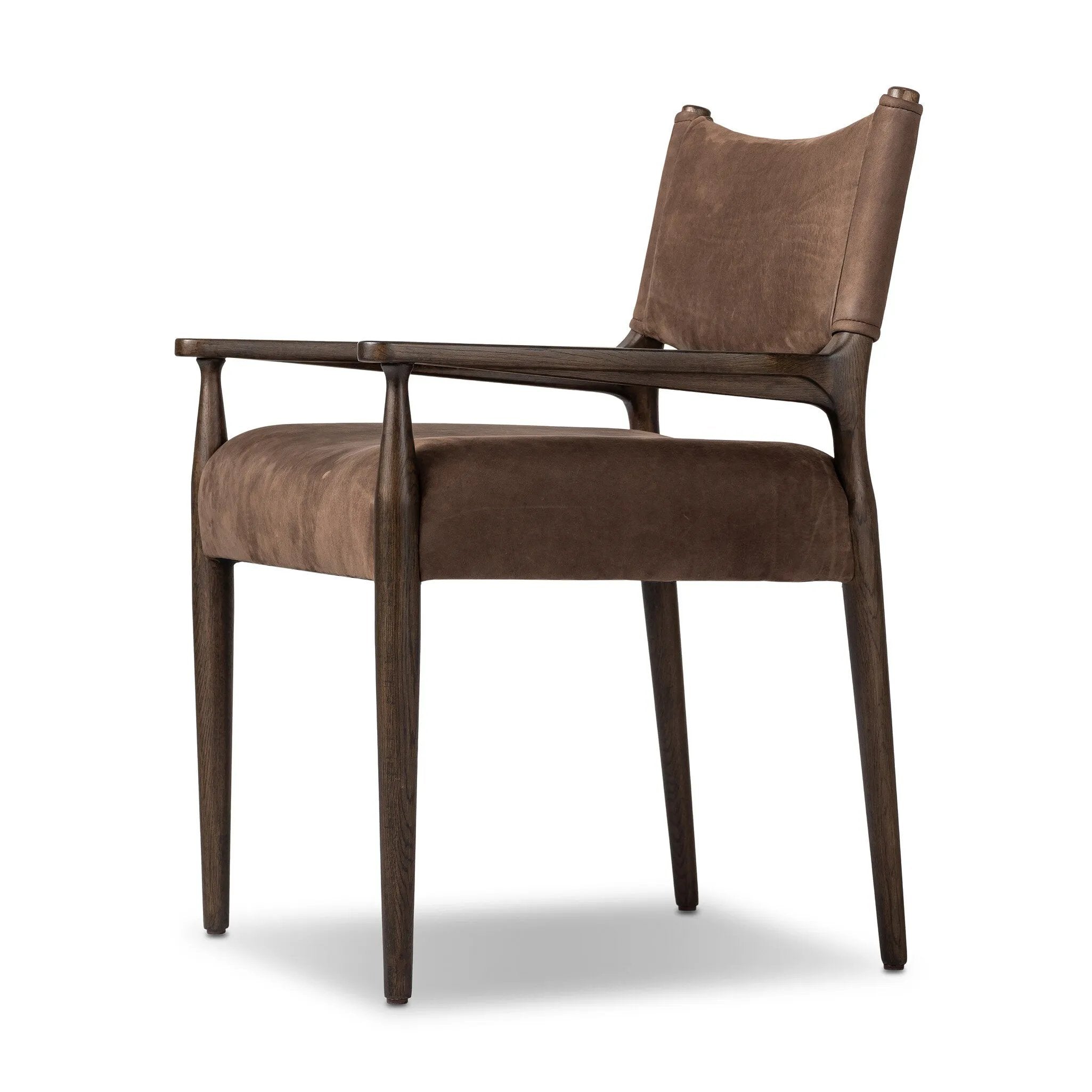 A midcentury-inspired piece brought to modern speed. A supportive, sling-style back and seat cushion are upholstered in a soft, velvety fabric, with toasted oak arms prime for the head of the table Amethyst Home provides interior design, new home construction design consulting, vintage area rugs, and lighting in the Scottsdale metro area.
