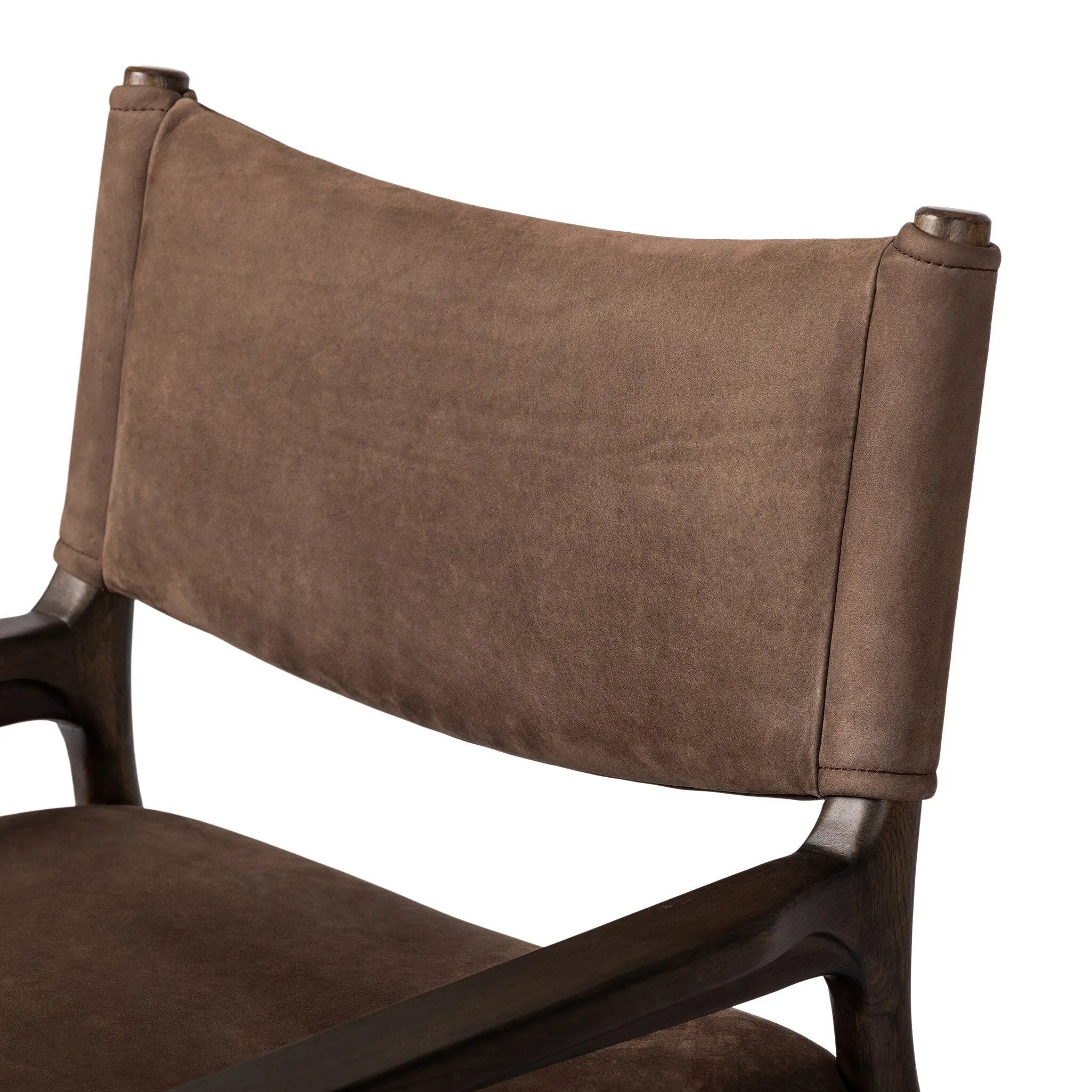 A midcentury-inspired piece brought to modern speed. A supportive, sling-style back and seat cushion are upholstered in a soft, velvety fabric, with toasted oak arms prime for the head of the table Amethyst Home provides interior design, new home construction design consulting, vintage area rugs, and lighting in the Seattle metro area.