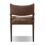 A midcentury-inspired piece brought to modern speed. A supportive, sling-style back and seat cushion are upholstered in a soft, velvety fabric, with toasted oak arms prime for the head of the table Amethyst Home provides interior design, new home construction design consulting, vintage area rugs, and lighting in the Tampa metro area.