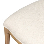 Bring a monochromatic, mixed-material look to the counter. Light solid oak shapes a curved seat back and sturdy frame for comfy seating upholstered with off-white performance fabric. A "handle" opening at the top of the seat back brings a touch of lightness to the look. Amethyst Home provides interior design, new home construction design consulting, vintage area rugs, and lighting in the Seattle metro area.
