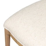 Bring a monochromatic, mixed-material look to the counter. Light solid oak shapes a curved seat back and sturdy frame for comfy seating upholstered with off-white performance fabric. A "handle" opening at the top of the seat back brings a touch of lightness to the look. Amethyst Home provides interior design, new home construction design consulting, vintage area rugs, and lighting in the Seattle metro area.