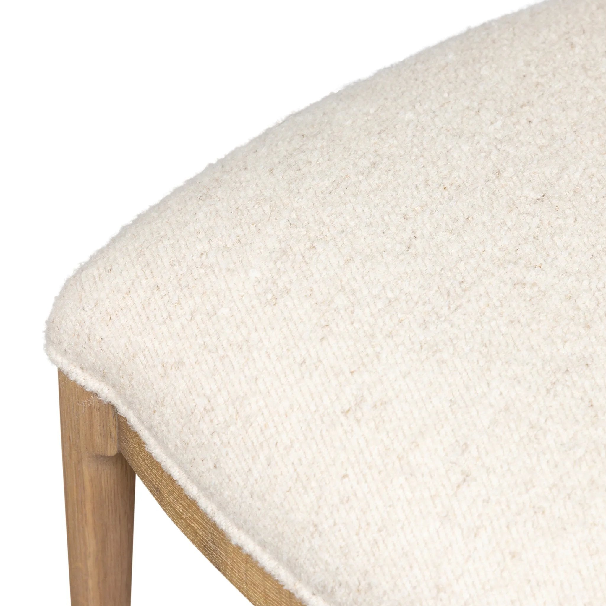 Bring a monochromatic, mixed-material look to the counter. Light solid oak shapes a curved seat back and sturdy frame for comfy seating upholstered with off-white performance fabric. A "handle" opening at the top of the seat back brings a touch of lightness to the look. Amethyst Home provides interior design, new home construction design consulting, vintage area rugs, and lighting in the Seattle metro area.