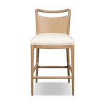 Bring a monochromatic, mixed-material look to the counter. Light solid oak shapes a curved seat back and sturdy frame for comfy seating upholstered with off-white performance fabric. A "handle" opening at the top of the seat back brings a touch of lightness to the look. Amethyst Home provides interior design, new home construction design consulting, vintage area rugs, and lighting in the Tampa metro area.