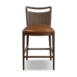 Bring a mixed-material look to the counter. Brown-finished solid oak shapes a curved seat back and sturdy frame for comfy seating upholstered with top-grain leather exclusive to Four Hands. A "handle" opening at the top of the seat back brings a touch of lightness to the look. Amethyst Home provides interior design, new home construction design consulting, vintage area rugs, and lighting in the Alpharetta metro area.