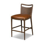 Bring a mixed-material look to the counter. Brown-finished solid oak shapes a curved seat back and sturdy frame for comfy seating upholstered with top-grain leather exclusive to Four Hands. A "handle" opening at the top of the seat back brings a touch of lightness to the look. Amethyst Home provides interior design, new home construction design consulting, vintage area rugs, and lighting in the Laguna Beach metro area.