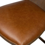 Bring a mixed-material look to the counter. Brown-finished solid oak shapes a curved seat back and sturdy frame for comfy seating upholstered with top-grain leather exclusive to Four Hands. A "handle" opening at the top of the seat back brings a touch of lightness to the look. Amethyst Home provides interior design, new home construction design consulting, vintage area rugs, and lighting in the Nashville metro area.