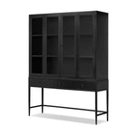 Featuring Jimi Black Cabinet by Four Hands at Amethyst Home. Storage-driven cabinetry inspired by angular geometry. Rich with monochromatic presence, a black-finished metal cabinet pairs with an airy iron base for a balance in scale. Three drawers bring even more storage, with bi-fold glass doors for display options. Minimalist bronzed hardware complete. Amethyst Home provides interior design, new home construction design consulting, vintage area rugs, and lighting in the Winter Garden metro area.