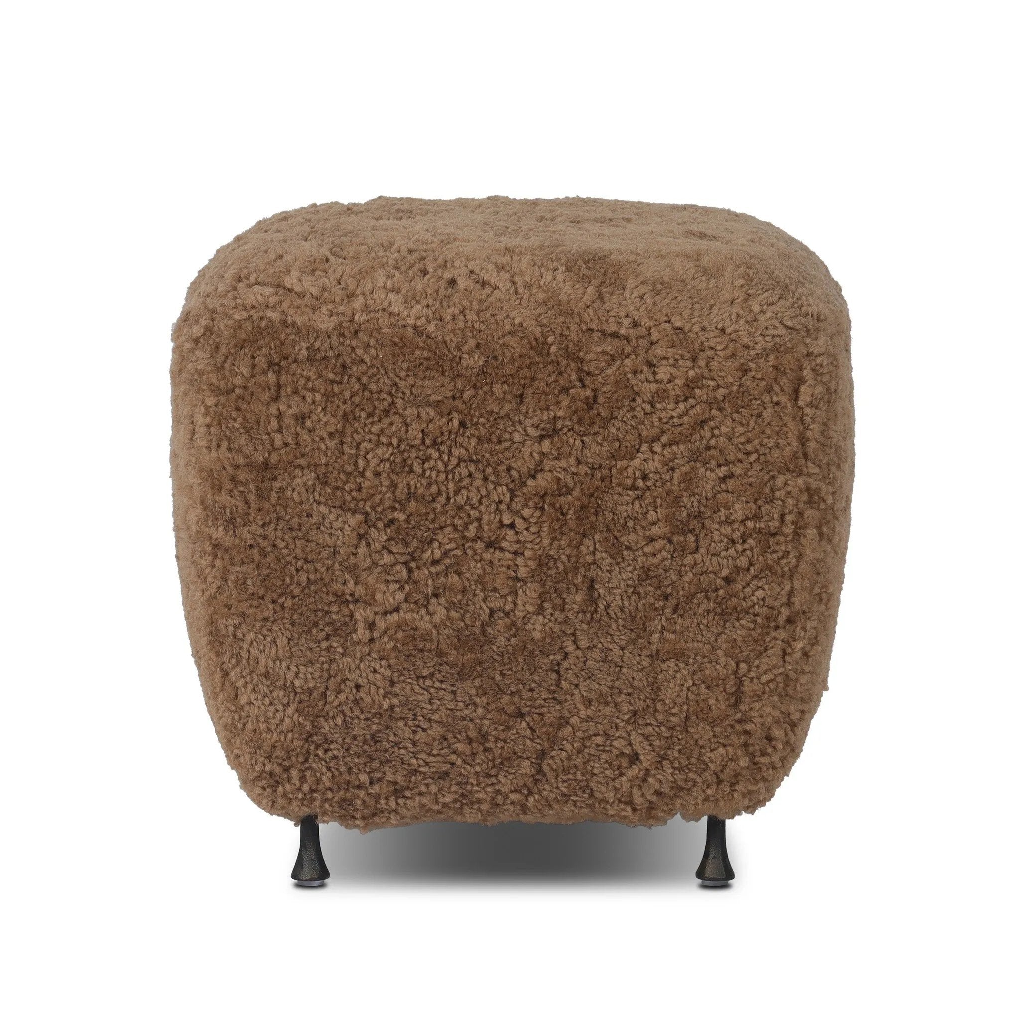 Small scale, big personality. This petite, shearling ottoman pairs a rounded upholstered seat with rugged, hammered black feet for a hand-crafted look.As lovers of modern materials at Amethyst, we love the nature inspired Joey Ottoman - Amber Shearling. This item pairs well with other brands such as Loloi Rugs and is perfect for coastal homes Amethyst Home provides interior design, new home construction design consulting, vintage area rugs, and lighting in the Alpharetta metro area.