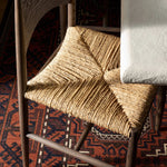 Featuring Jovan Stained Saddle Brown Dining Chair by Four Hands at Amethyst Home. A seamless addition to your dining collection, a slim-profile dining chair pairs a woven banana leaf seat with a solid oak frame featuring a bentwood back. Overall Dimensions: 20.00"w x 22.25"d x 37.00"h. Amethyst Home provides interior design, new home construction design consulting, vintage area rugs, and lighting in the Kansas City metro area.