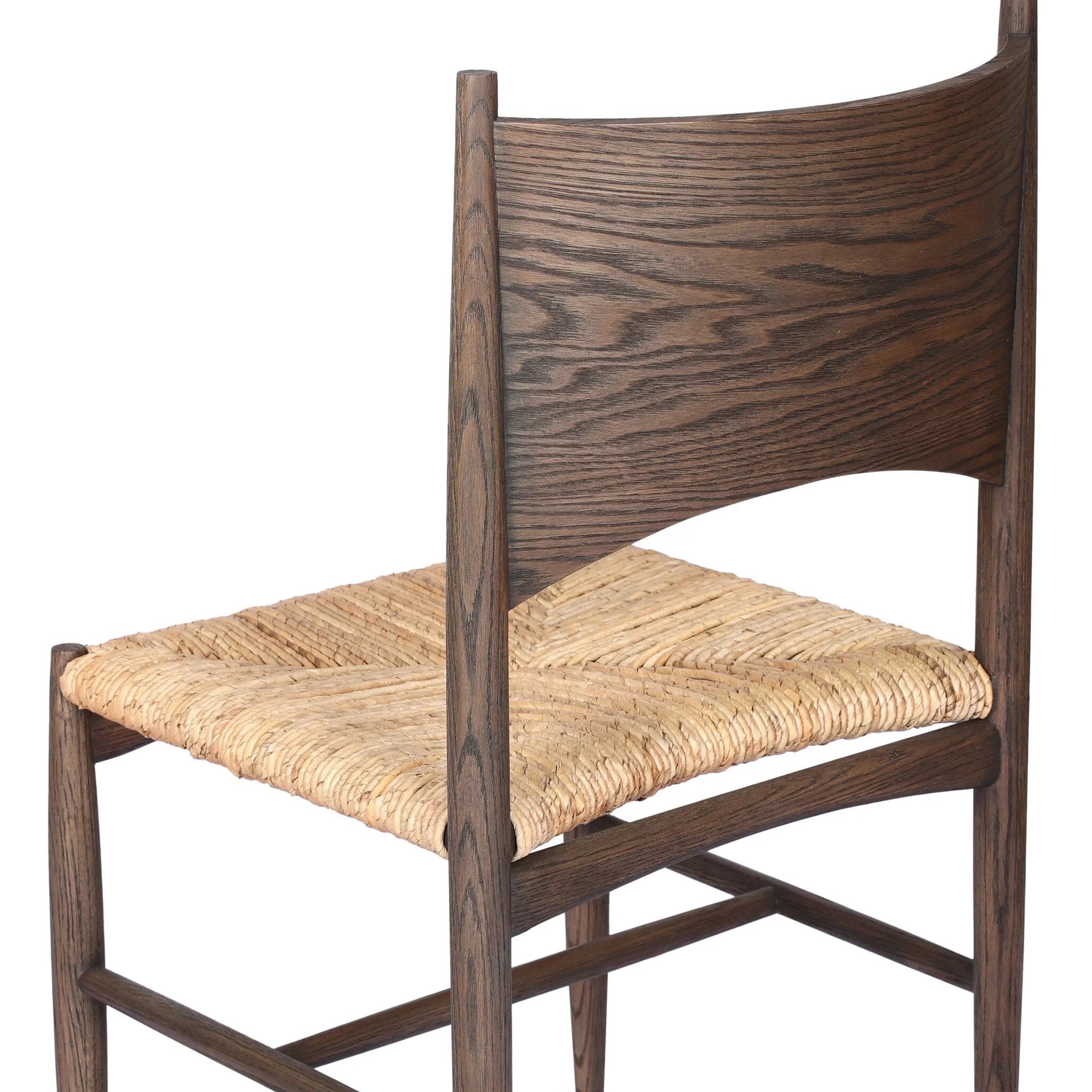 Featuring Jovan Stained Saddle Brown Dining Chair by Four Hands at Amethyst Home. A seamless addition to your dining collection, a slim-profile dining chair pairs a woven banana leaf seat with a solid oak frame featuring a bentwood back. Overall Dimensions: 20.00"w x 22.25"d x 37.00"h. Amethyst Home provides interior design, new home construction design consulting, vintage area rugs, and lighting in the Laguna Beach metro area.