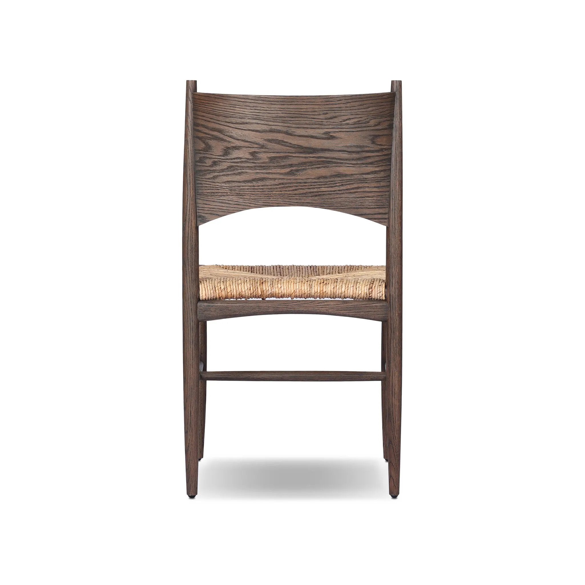 Featuring Jovan Stained Saddle Brown Dining Chair by Four Hands at Amethyst Home. A seamless addition to your dining collection, a slim-profile dining chair pairs a woven banana leaf seat with a solid oak frame featuring a bentwood back. Overall Dimensions: 20.00"w x 22.25"d x 37.00"h. Amethyst Home provides interior design, new home construction design consulting, vintage area rugs, and lighting in the Nashville metro area.