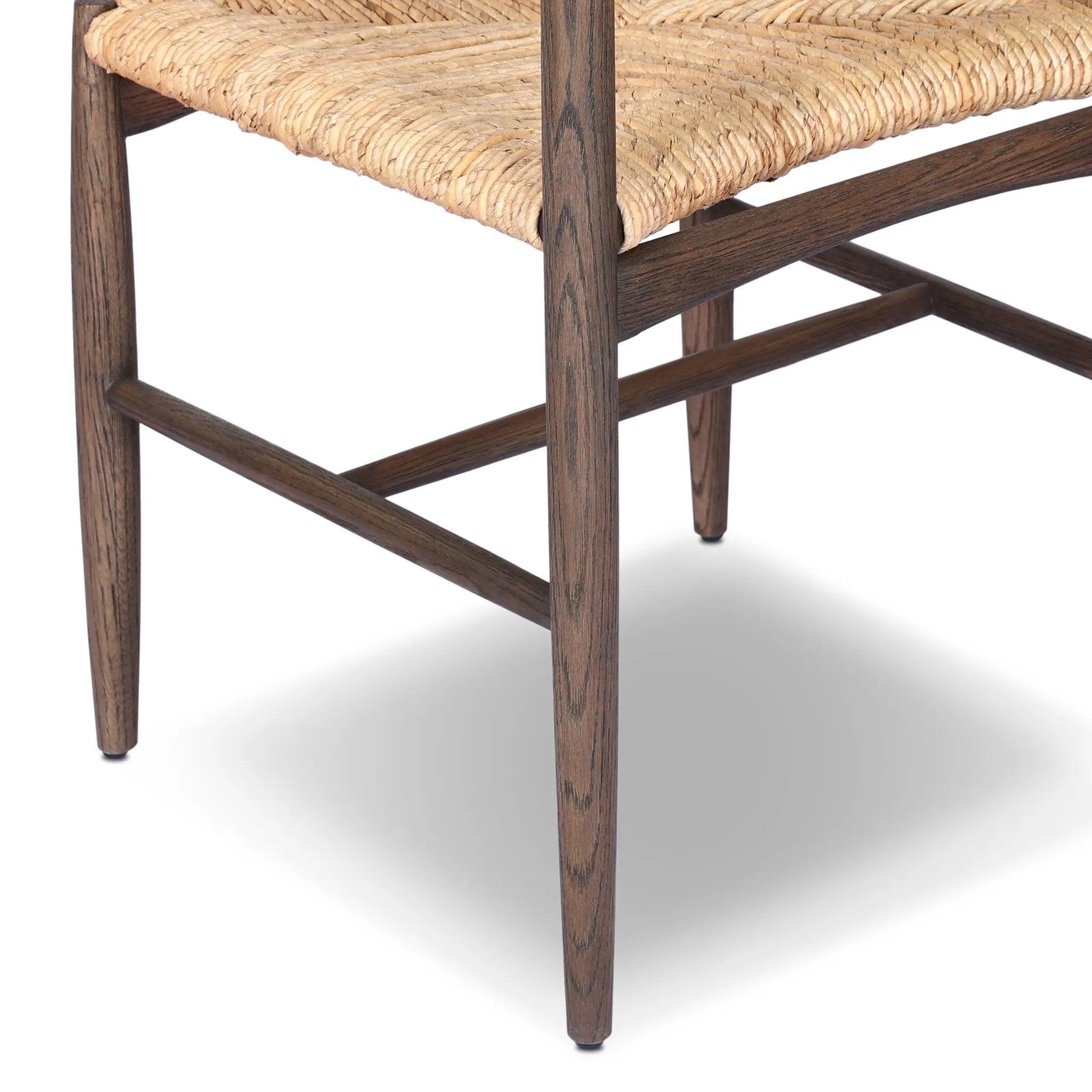 Featuring Jovan Stained Saddle Brown Dining Chair by Four Hands at Amethyst Home. A seamless addition to your dining collection, a slim-profile dining chair pairs a woven banana leaf seat with a solid oak frame featuring a bentwood back. Overall Dimensions: 20.00"w x 22.25"d x 37.00"h. Amethyst Home provides interior design, new home construction design consulting, vintage area rugs, and lighting in the Omaha metro area.