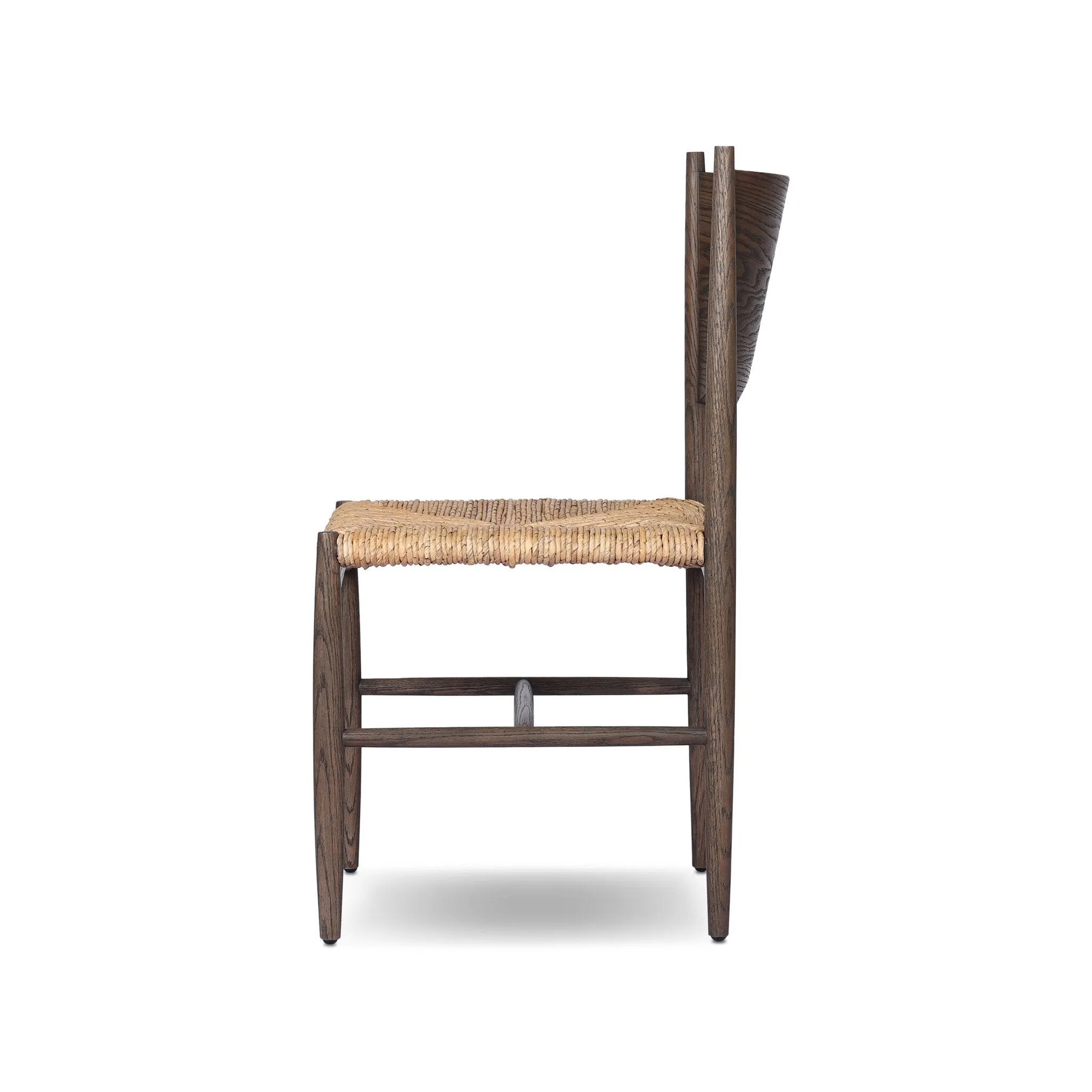 Featuring Jovan Stained Saddle Brown Dining Chair by Four Hands at Amethyst Home. A seamless addition to your dining collection, a slim-profile dining chair pairs a woven banana leaf seat with a solid oak frame featuring a bentwood back. Overall Dimensions: 20.00"w x 22.25"d x 37.00"h. Amethyst Home provides interior design, new home construction design consulting, vintage area rugs, and lighting in the Salt Lake City metro area.