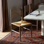 Featuring Jovan Stained Saddle Brown Dining Chair by Four Hands at Amethyst Home. A seamless addition to your dining collection, a slim-profile dining chair pairs a woven banana leaf seat with a solid oak frame featuring a bentwood back. Overall Dimensions: 20.00"w x 22.25"d x 37.00"h. Amethyst Home provides interior design, new home construction design consulting, vintage area rugs, and lighting in the Winter Garden metro area.