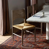 Featuring Jovan Stained Saddle Brown Dining Chair by Four Hands at Amethyst Home. A seamless addition to your dining collection, a slim-profile dining chair pairs a woven banana leaf seat with a solid oak frame featuring a bentwood back. Overall Dimensions: 20.00"w x 22.25"d x 37.00"h. Amethyst Home provides interior design, new home construction design consulting, vintage area rugs, and lighting in the Winter Garden metro area.