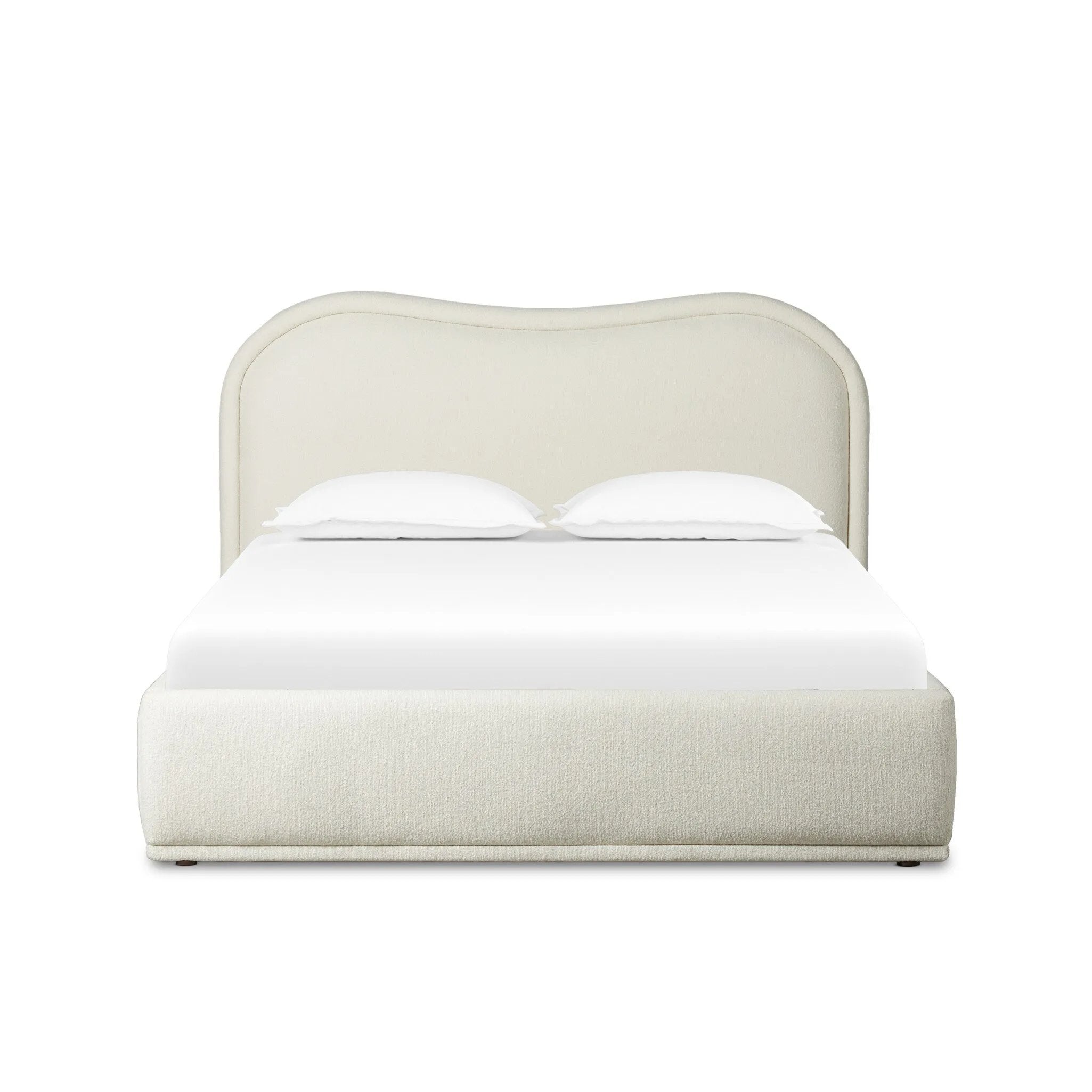 Swooping curves and full upholstery make for an elegant combination. Cream fabric wraps generous cushioning all around, giving textural depth to the bed Amethyst Home provides interior design, new home construction design consulting, vintage area rugs, and lighting in the Salt Lake City metro area.
