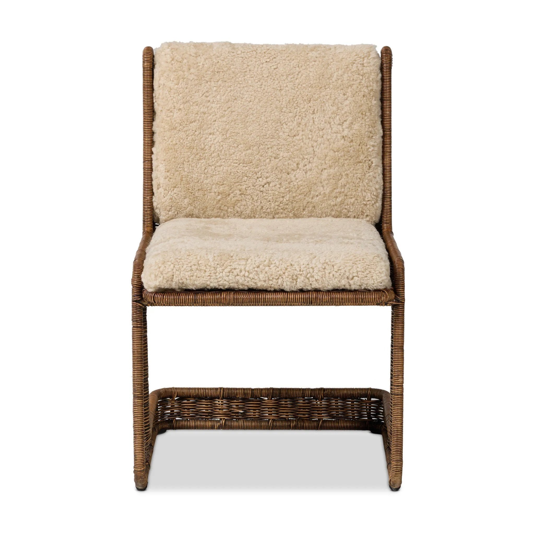 Contours and cantilevers define this Seventies-inspired dining chair. A woven sculptural frame of natural rattan bolsters textural shearling cushions for max comfort.As fans of wabi sabi materials at Amethyst, we love the warm modern inspired Katrine Dining Chair - Beige Shorn Shearling. Amethyst Home provides interior design, new home construction design consulting, vintage area rugs, and lighting in the Houston metro area.