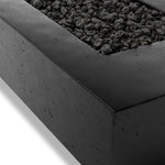 This outdoor fire table is a welcoming centerpiece designed for gathering. Made from glass-reinforced concrete, each piece is naturally finished with deep tones of charcoal. The monolithic shape is completed with lavastones in the center, bringing together a bold, monochromatic look. Amethyst Home provides interior design, new home construction design consulting, vintage area rugs, and lighting in the Alpharetta metro area.