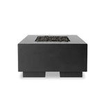 This outdoor fire table is a welcoming centerpiece designed for gathering. Made from glass-reinforced concrete, each piece is naturally finished with deep tones of charcoal. The monolithic shape is completed with lavastones in the center, bringing together a bold, monochromatic look. Amethyst Home provides interior design, new home construction design consulting, vintage area rugs, and lighting in the Tampa metro area.