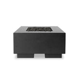 This outdoor fire table is a welcoming centerpiece designed for gathering. Made from glass-reinforced concrete, each piece is naturally finished with deep tones of charcoal. The monolithic shape is completed with lavastones in the center, bringing together a bold, monochromatic look. Amethyst Home provides interior design, new home construction design consulting, vintage area rugs, and lighting in the Tampa metro area.
