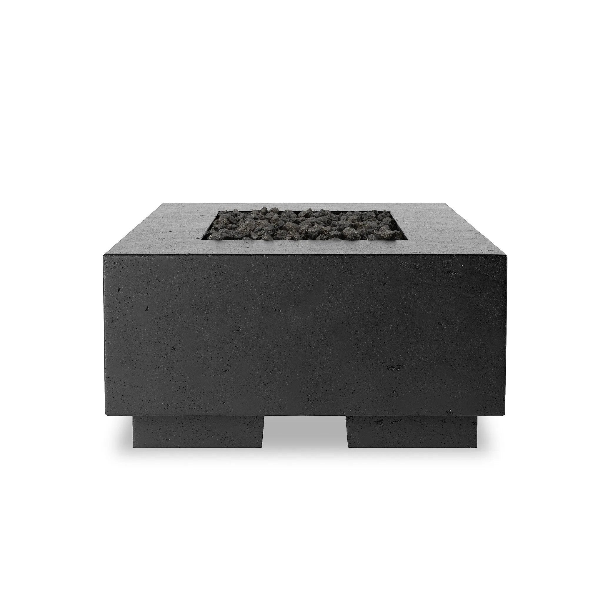 This outdoor fire table is a welcoming centerpiece designed for gathering. Made from glass-reinforced concrete, each piece is naturally finished with deep tones of charcoal. The monolithic shape is completed with lavastones in the center, bringing together a bold, monochromatic look. Amethyst Home provides interior design, new home construction design consulting, vintage area rugs, and lighting in the Tampa metro area.