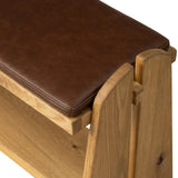 Style this versatile bench just about anywhere. A light, toasted oak frame shapes tapered paddle legs, with relief and split-leg detailing for a design-forward look. A thin layer of brown top-grain leather brings warmth and comfort to the whole look. Amethyst Home provides interior design, new home construction design consulting, vintage area rugs, and lighting in the Boston metro area.