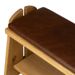 Style this versatile bench just about anywhere. A light, toasted oak frame shapes tapered paddle legs, with relief and split-leg detailing for a design-forward look. A thin layer of brown top-grain leather brings warmth and comfort to the whole look. Amethyst Home provides interior design, new home construction design consulting, vintage area rugs, and lighting in the Scottsdale metro area.