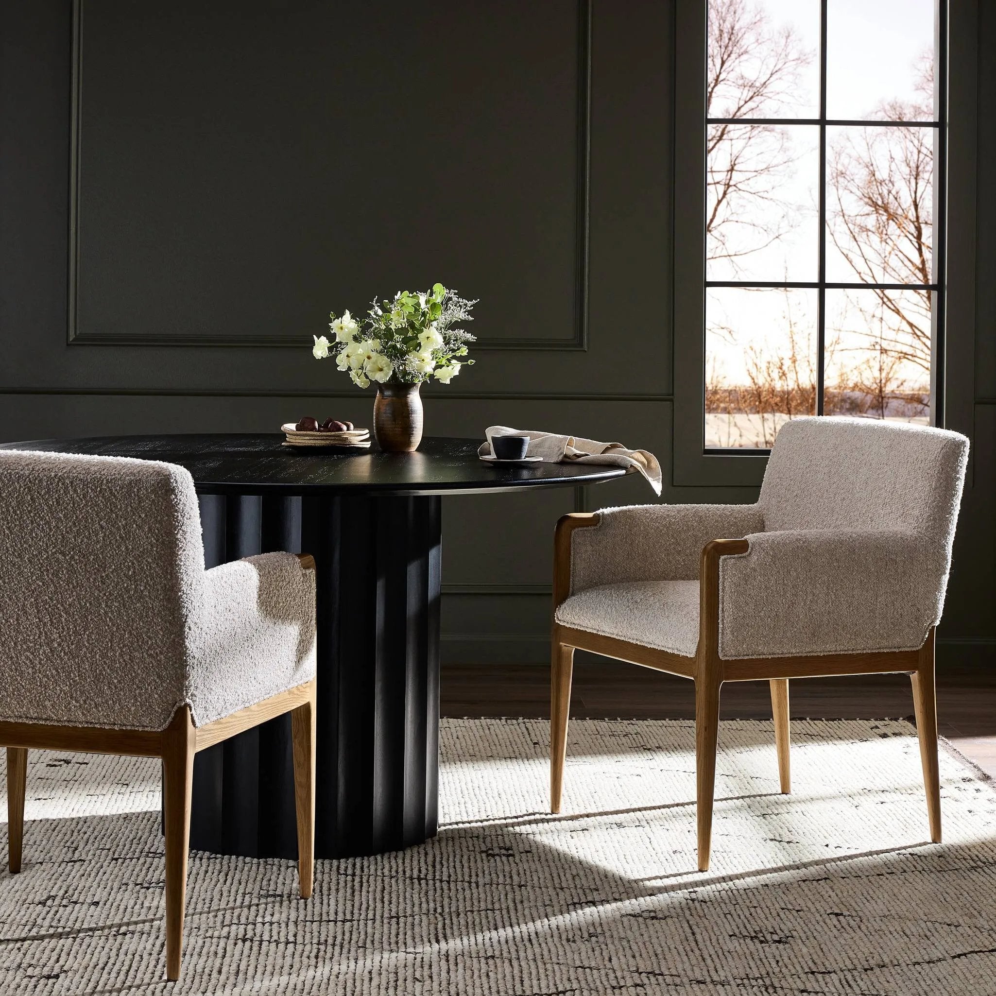 A box-profile dining chair that’s all about comfort. Exposed oak legs flow seamlessly into the chair's upholstered arms, for a seamless look. Performance fabrics are specially created to withstand spills, stains, high traffic and wear, ensuring long-term comfort and unmatched durability Amethyst Home provides interior design, new home construction design consulting, vintage area rugs, and lighting in the Kansas City metro area.