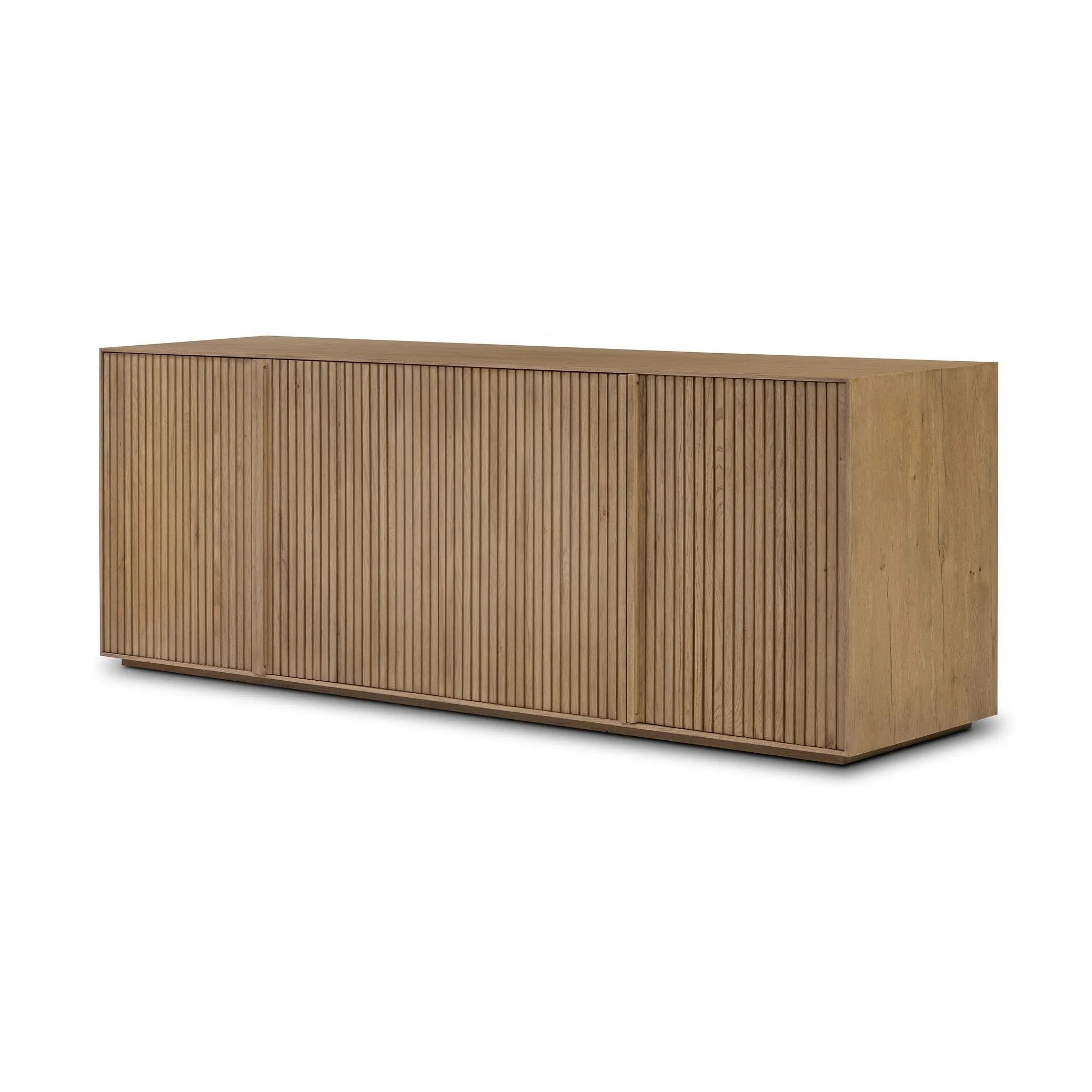 Made from rustic-finished oak with a plinth-style base, clean angles and linear reeding define this midcentury-spirited sideboard. Fully finished interior for a beautiful look inside and out. Designed in partnership with longtime Four Hands collaborator Thomas Bina and Brazilian designer Ronald Sasson Amethyst Home provides interior design, new home construction design consulting, vintage area rugs, and lighting in the Los Angeles metro area.