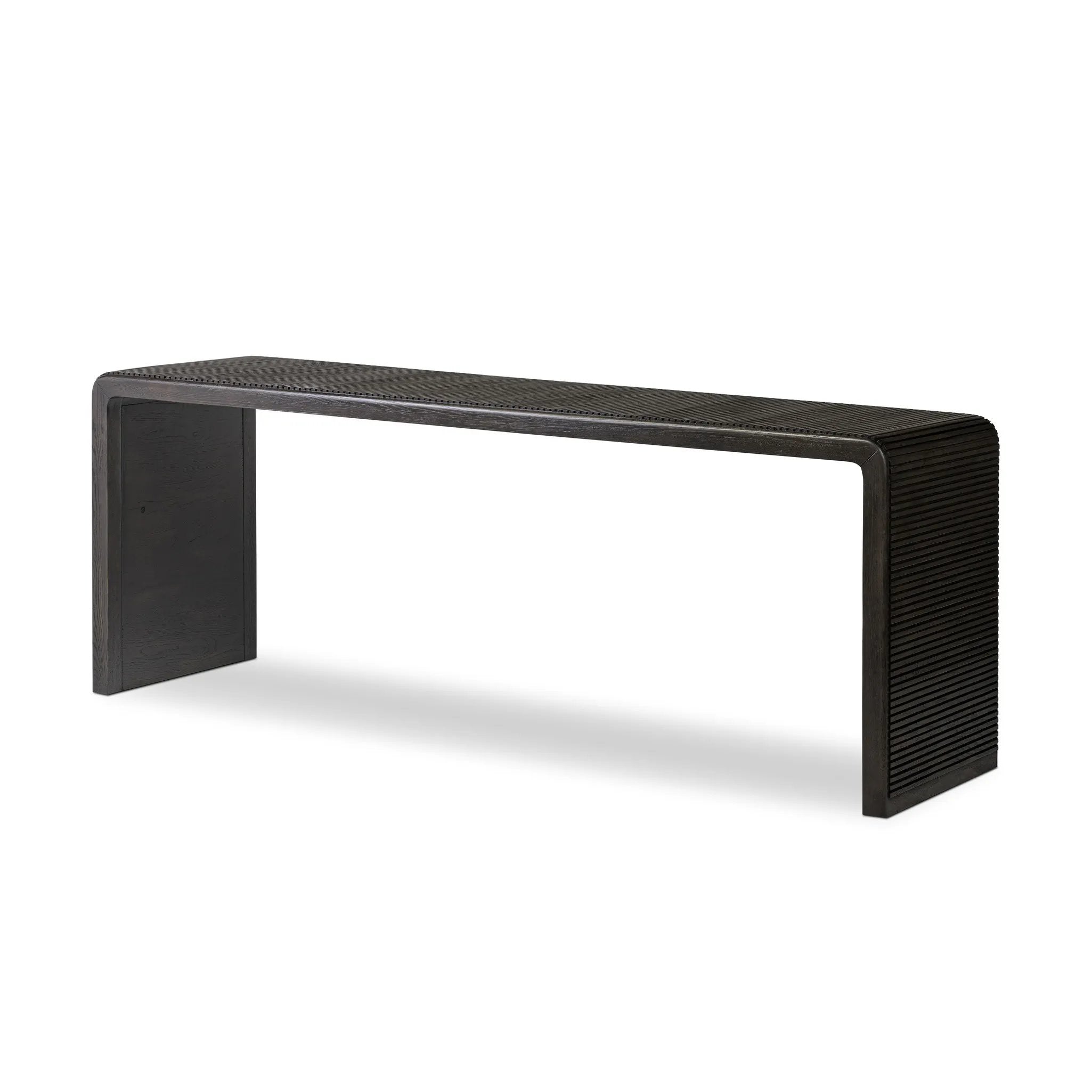 Smoked black oak shapes an elongated console table, rich with reeding. Subtly rounded edges reflect Brazilian midcentury inspiration behind this crafted minimalist piece. Designed in partnership with longtime Four Hands collaborator Thomas Bina and designer Ronald Sasson Amethyst Home provides interior design, new home construction design consulting, vintage area rugs, and lighting in the Winter Garden metro area.