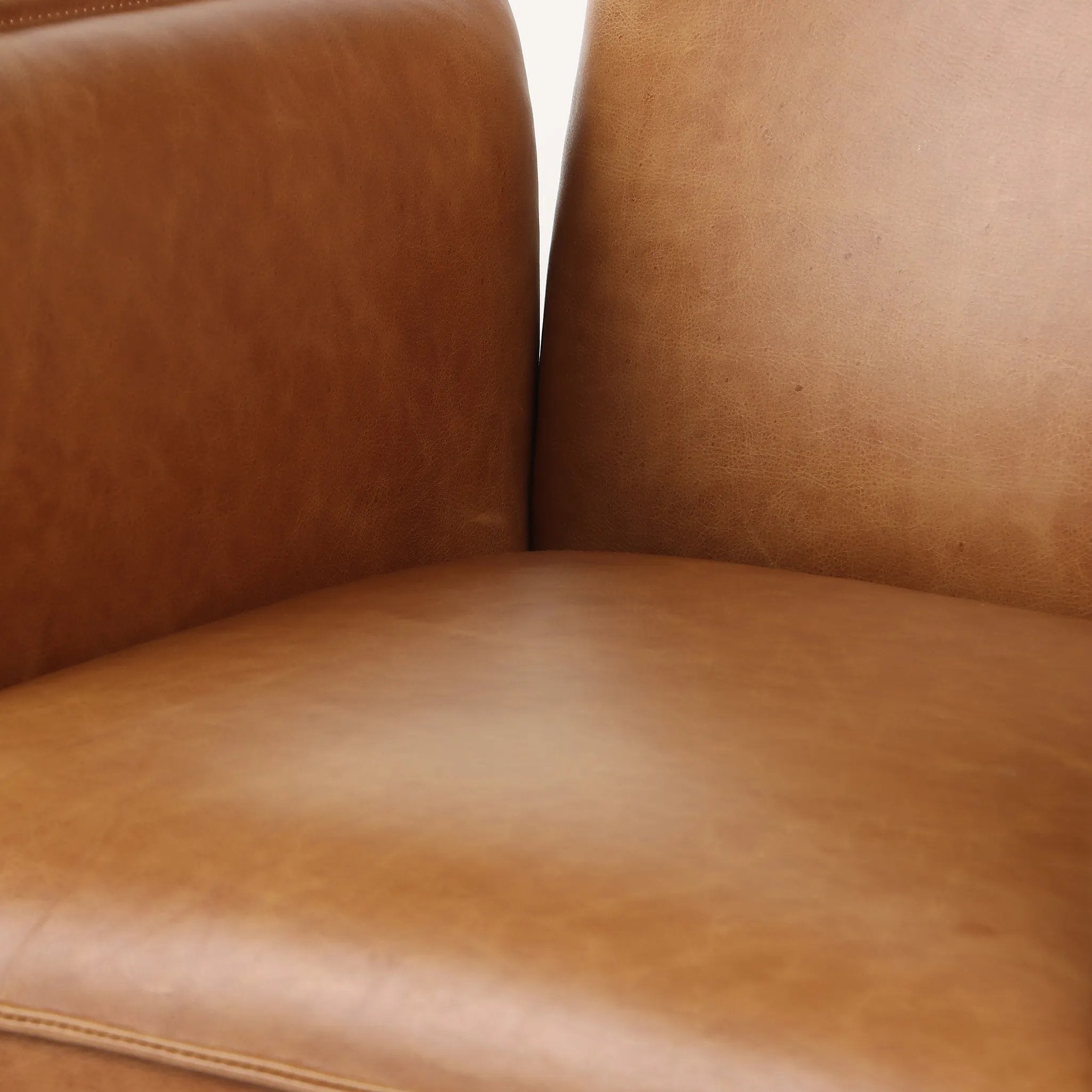Wrapped in buttery-soft tan top-grain leather, this structured, high-back chair is designed for comfort and style. Stainless steel casters and a 360-degree swivel for ease in the modern workspace Amethyst Home provides interior design, new home construction design consulting, vintage area rugs, and lighting in the Tampa metro area.