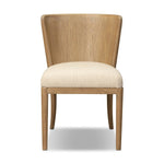 The barrel back dining chair, refreshed. Light oak shapes an armless frame and curved rear legs that almost appear to flow into the seat back. A comfy seat is upholstered in high-performance fabric, while reeding details on the back create a sense of perception play. Amethyst Home provides interior design, new home construction design consulting, vintage area rugs, and lighting in the Alpharetta metro area.