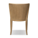 The barrel back dining chair, refreshed. Light oak shapes an armless frame and curved rear legs that almost appear to flow into the seat back. A comfy seat is upholstered in high-performance fabric, while reeding details on the back create a sense of perception play. Amethyst Home provides interior design, new home construction design consulting, vintage area rugs, and lighting in the Portland metro area.