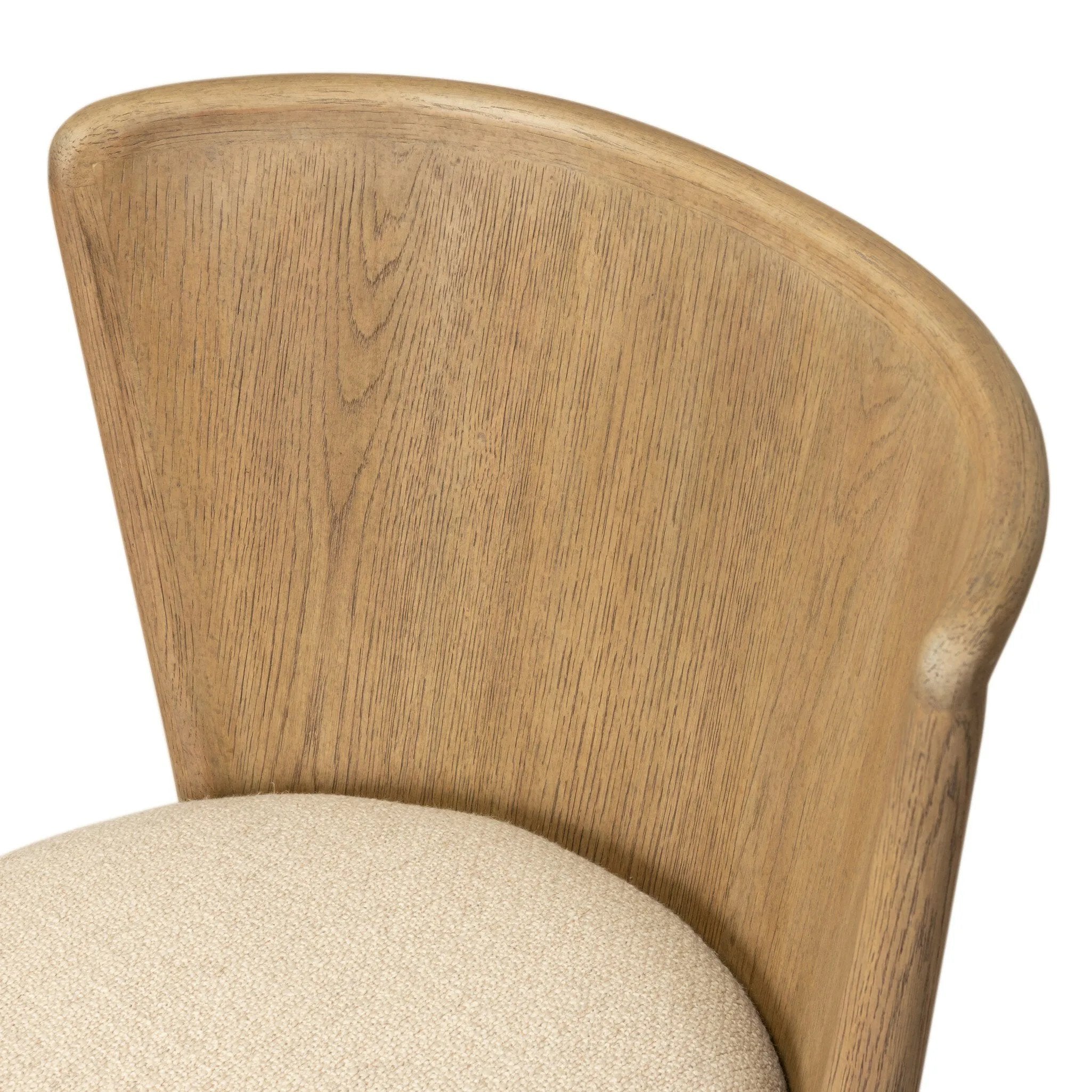 The barrel back dining chair, refreshed. Light oak shapes an armless frame and curved rear legs that almost appear to flow into the seat back. A comfy seat is upholstered in high-performance fabric, while reeding details on the back create a sense of perception play. Amethyst Home provides interior design, new home construction design consulting, vintage area rugs, and lighting in the Winter Garden metro area.