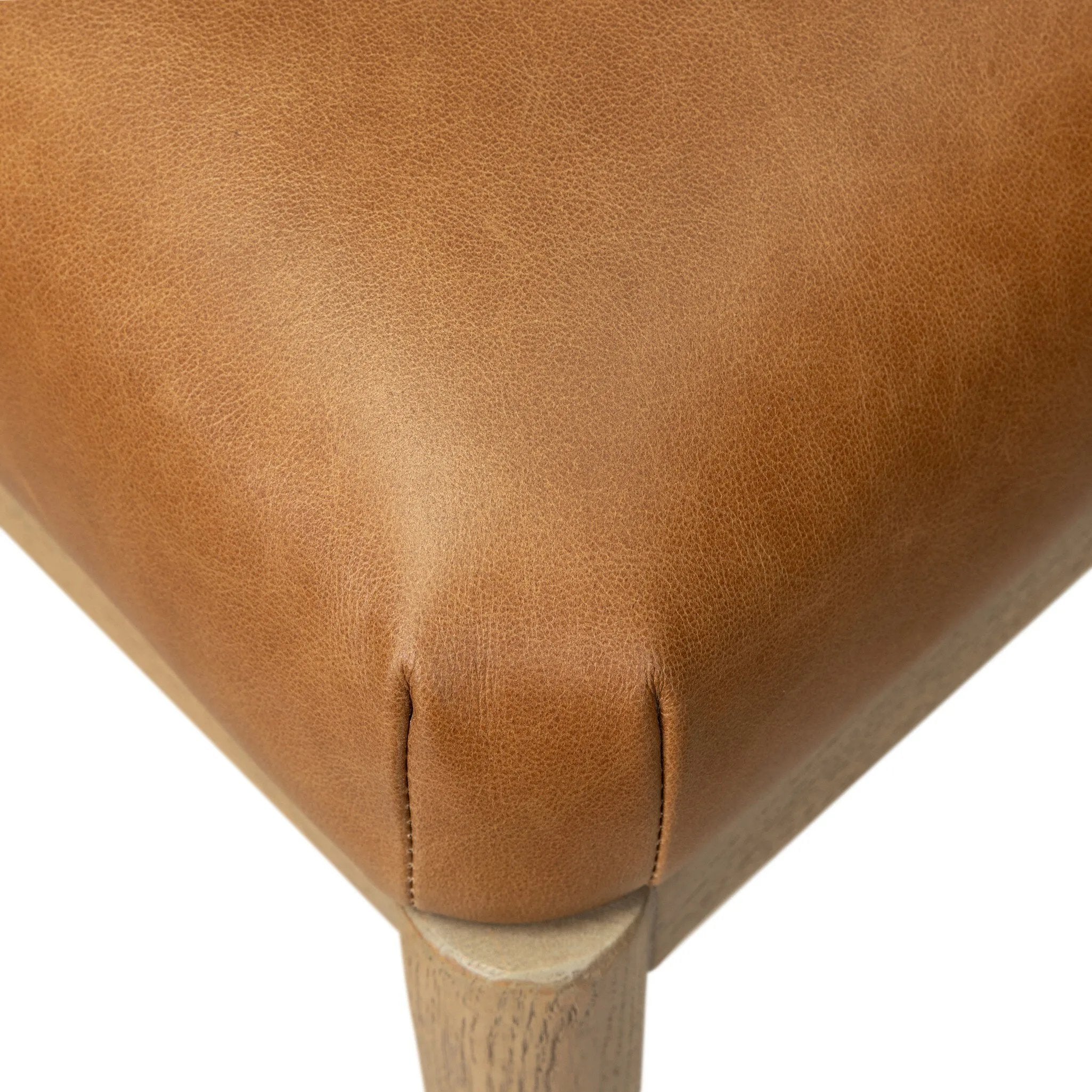 The barrel back dining chair, refreshed. Light oak shapes an armless frame and curved rear legs that almost appear to flow into the seat back. A comfy seat is upholstered in chestnut top-grain leather, while reeding details on the back create a sense of perception play. Amethyst Home provides interior design, new home construction design consulting, vintage area rugs, and lighting in the Seattle metro area.
