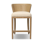 The barrel back counter stool, refreshed. Light oak shapes an armless frame and curved rear legs that almost appear to flow into the seat back. A comfy seat is upholstered in high-performance fabric, while reeding details create a sense of perception play. Amethyst Home provides interior design, new home construction design consulting, vintage area rugs, and lighting in the Houston metro area.