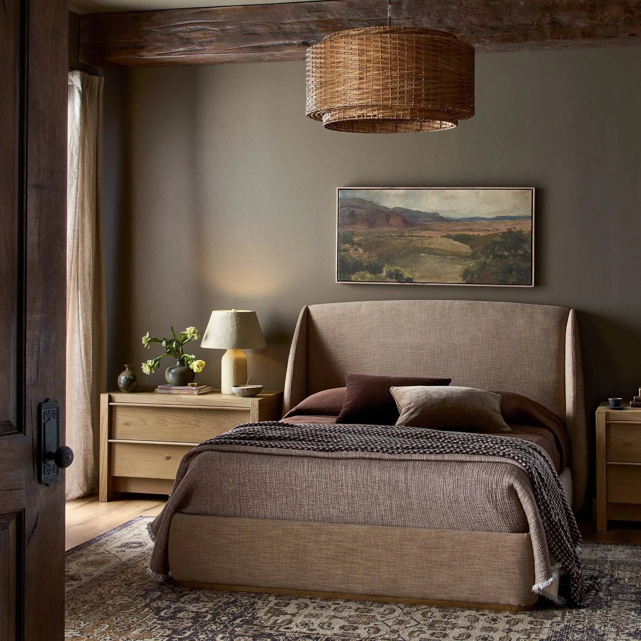 Clean lines meet contoured curves for a timeless bedroom look. A petal-shaped shelter overlaps side rails for a unique,  comforting silhouette. Fully upholstered in a versatile taupe that complements a wide range of color palettes Amethyst Home provides interior design, new home construction design consulting, vintage area rugs, and lighting in the Charlotte metro area.