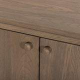 A smaller scale and antique-inspired oval shape give this sideboard a classic polished look. A slight overhang of the top and bottom slabs adds visual interest, while simple ball-shaped hardware mimics this sideboard's unique bun feet. Amethyst Home provides interior design, new home construction design consulting, vintage area rugs, and lighting in the Charlotte metro area.