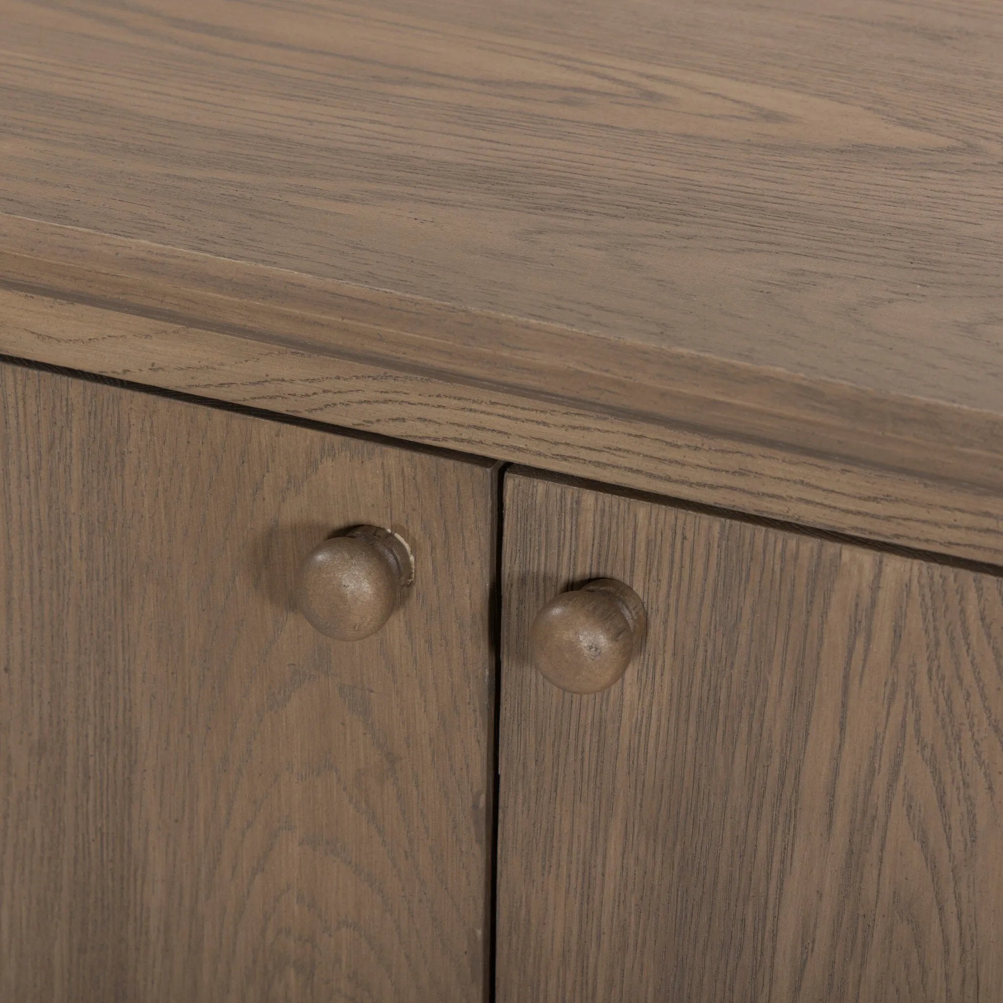 A smaller scale and antique-inspired oval shape give this sideboard a classic polished look. A slight overhang of the top and bottom slabs adds visual interest, while simple ball-shaped hardware mimics this sideboard's unique bun feet. Amethyst Home provides interior design, new home construction design consulting, vintage area rugs, and lighting in the Charlotte metro area.
