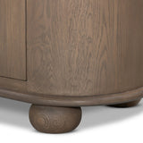 A smaller scale and antique-inspired oval shape give this sideboard a classic polished look. A slight overhang of the top and bottom slabs adds visual interest, while simple ball-shaped hardware mimics this sideboard's unique bun feet. Amethyst Home provides interior design, new home construction design consulting, vintage area rugs, and lighting in the Nashville metro area.
