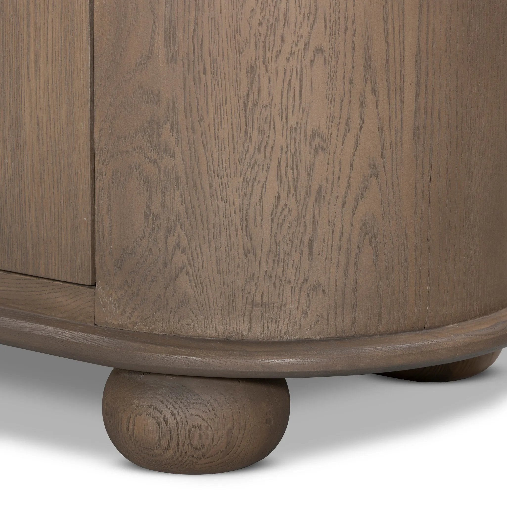 A smaller scale and antique-inspired oval shape give this sideboard a classic polished look. A slight overhang of the top and bottom slabs adds visual interest, while simple ball-shaped hardware mimics this sideboard's unique bun feet. Amethyst Home provides interior design, new home construction design consulting, vintage area rugs, and lighting in the Nashville metro area.