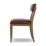 Both modern and traditional, toasted oak frames this high-back, armless dining chair. Finished with a rich brown top-grain leather, with hanging straps affixed to the back Amethyst Home provides interior design, new home construction design consulting, vintage area rugs, and lighting in the Calabasas metro area.