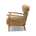 Classic Scandinavian design gets a supersoft update with a winged back panel of amber-finished oak floating above a chunky seat with exposed spindles. Paddle arms and ball feet add to the minimalist design. Covered in natural beige shearling for extra texture and comfort Amethyst Home provides interior design, new home construction design consulting, vintage area rugs, and lighting in the Boston metro area.